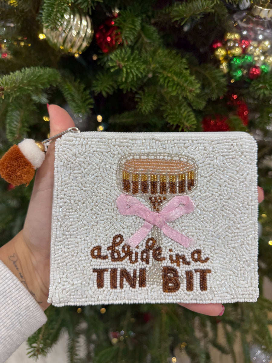 A BRIDE IN A TINI BIT COIN BAG