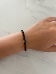 BLACK BEADED/GOLD CHAIN BRACELET